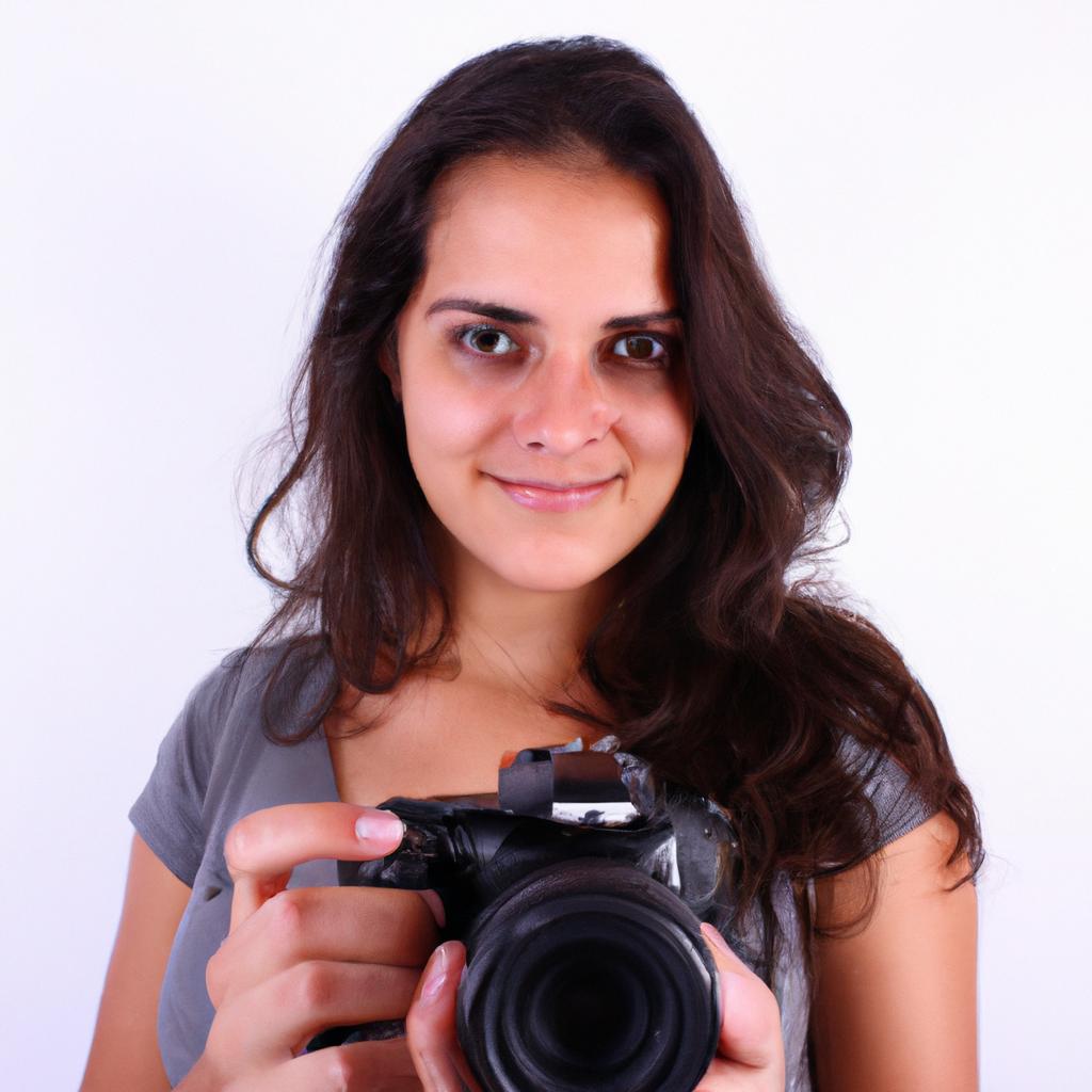 Person holding a camera, smiling