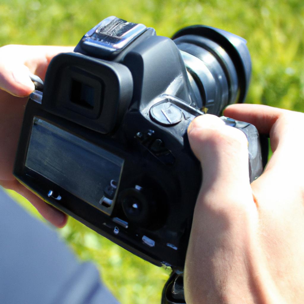 Person adjusting camera settings outdoors